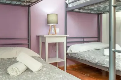 a bedroom with two bunk beds and a table with a lamp at Esperanza free parking by Staycare in Rota