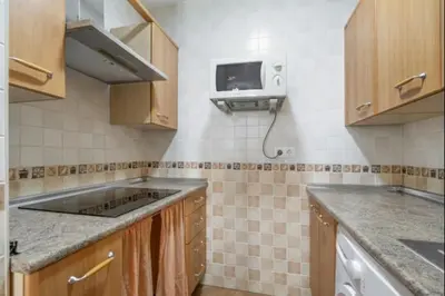 a kitchen with a sink and a tv on the wall at Esperanza free parking by Staycare in Rota