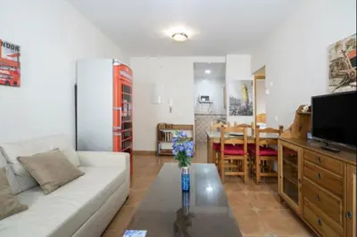 a living room with a white couch and a table at Esperanza free parking by Staycare in Rota