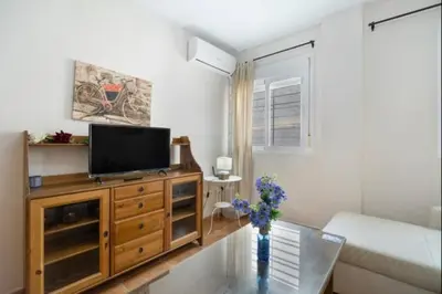 a living room with a television on a wooden dresser at Esperanza free parking by Staycare in Rota