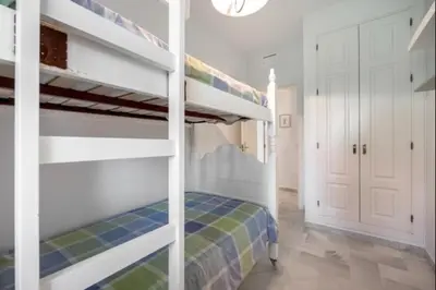 a bedroom with two bunk beds and a hallway at Paraíso del golf free parking by Staycare in Rota