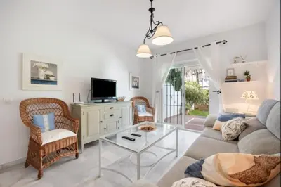 a living room with a couch and a table at Paraíso del golf free parking by Staycare in Rota