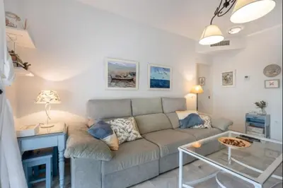 a living room with a couch and a table at Paraíso del golf free parking by Staycare in Rota