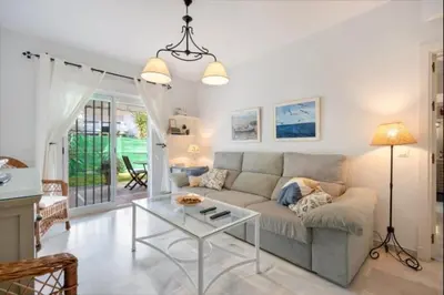 a living room with a couch and a table at Paraíso del golf free parking by Staycare in Rota