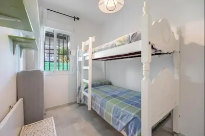 a bedroom with two bunk beds in a room at Paraíso del golf free parking by Staycare in Rota