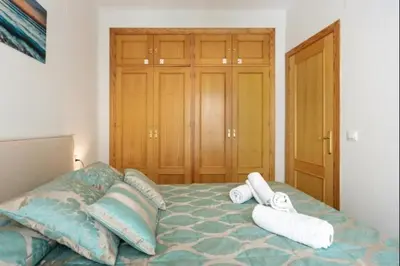 a bedroom with a bed with two towels on it at Isaac Peral by Staycare in Rota