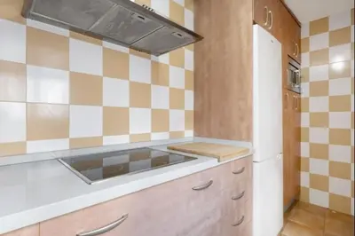 a kitchen with a sink and a refrigerator at Isaac Peral by Staycare in Rota