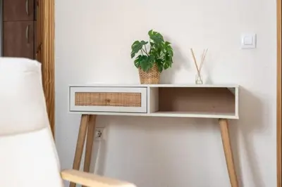 a white shelf with a plant on a wall at Isaac Peral by Staycare in Rota