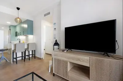 a living room with a large flat screen tv at Isla Candor free parking by Staycare in Rota