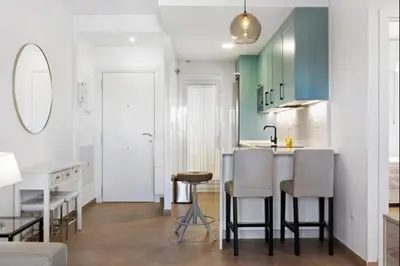 a kitchen with a table and chairs in a room at Isla Candor free parking by Staycare in Rota