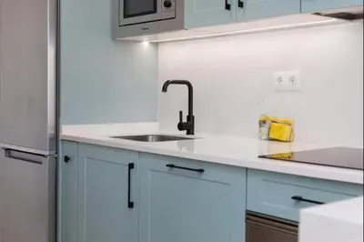 a white kitchen with a sink and a refrigerator at Isla Candor free parking by Staycare in Rota