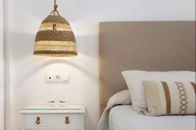 a bedroom with a bed with a night stand and a lamp at Isla Candor free parking by Staycare in Rota