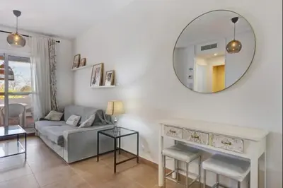 a living room with a couch and a mirror at Isla Candor free parking by Staycare in Rota