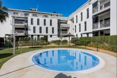 a large swimming pool in front of a building at La Atalaya free parking by Staycare in Rota
