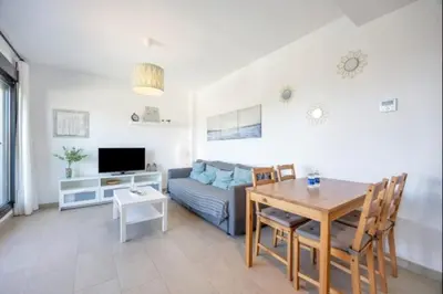 a living room with a table and a couch at La Atalaya free parking by Staycare in Rota