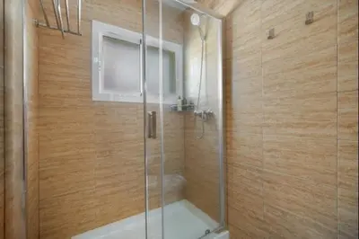 a bathroom with a shower with a glass door at Ecija Playa Rota by Staycare in Rota