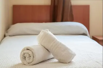 a towel animal laying on top of a bed at Ecija Playa Rota by Staycare in Rota