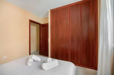 a bedroom with a bed with towels on it at Ecija Playa Rota by Staycare in Rota