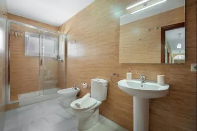 a bathroom with a toilet and a sink and a shower at Ecija Playa Rota by Staycare in Rota