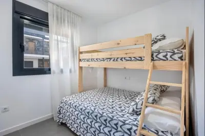 a bedroom with two bunk beds and a ladder at Nerea Rota free parking by Staycare in Rota