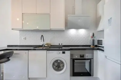 a white kitchen with a washing machine in it at Nerea Rota free parking by Staycare in Rota