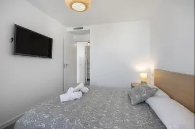 a bedroom with a bed with a flat screen tv at Nerea Rota free parking by Staycare in Rota