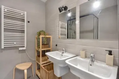 a bathroom with two sinks and a mirror and a stool at Nerea Rota free parking by Staycare in Rota