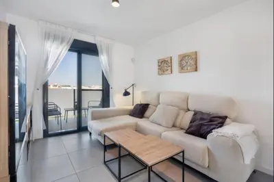 a living room with a white couch and a table at Nerea Rota free parking by Staycare in Rota