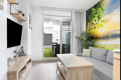 a living room with a couch and a tv at Paraíso Candor free parking by Staycare in Rota