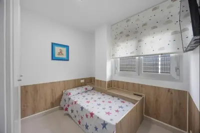 a bedroom with a bed and a climbing wall at Paraíso Candor free parking by Staycare in Rota