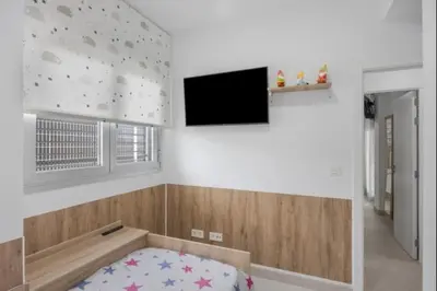 a room with a bed and a flat screen tv at Paraíso Candor free parking by Staycare in Rota