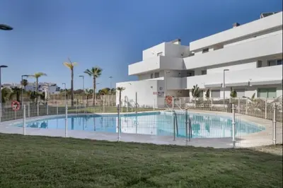 a swimming pool in front of a building at Paraíso Candor free parking by Staycare in Rota