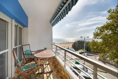 a balcony with chairs and a table and a view of the beach at Pinar del Mar by Staycare in Rota