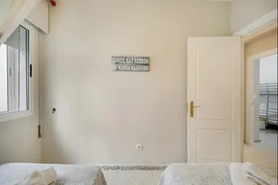 a bedroom with a bed and a sign on the wall at Pinar del Mar by Staycare in Rota