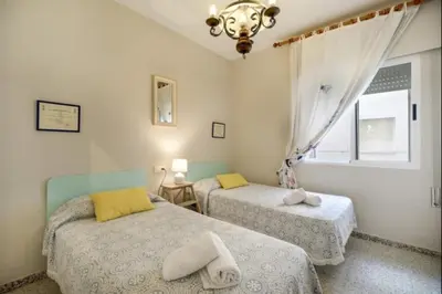 a bedroom with two beds and a window at Pinar del Mar by Staycare in Rota