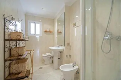 a bathroom with a toilet and a sink and a shower at Pinar del Mar by Staycare in Rota