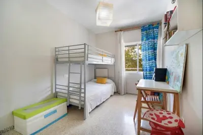 a small bedroom with a bunk bed and a desk at Pinar del Mar by Staycare in Rota