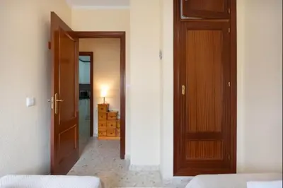 a room with two wooden doors and a bedroom at Sorolla Rota free parking by Staycare in Rota