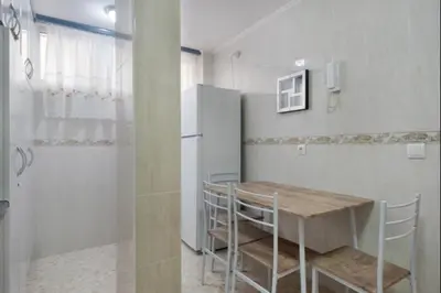 a dining room with a table and a refrigerator at Sorolla Rota free parking by Staycare in Rota