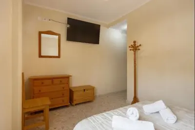 a bedroom with a bed and a dresser and a tv at Sorolla Rota free parking by Staycare in Rota