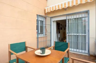 a table and chairs on a balcony with a cup on it at Sorolla Rota free parking by Staycare in Rota