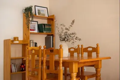 a wooden table and chairs with a vase on it at Sorolla Rota free parking by Staycare in Rota