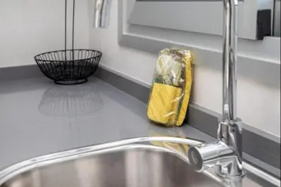 a kitchen sink with a yellow bag on the counter at Luar Candor free parking by Staycare in Rota