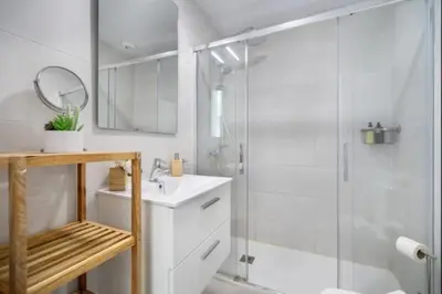 a white bathroom with a shower and a sink at Luar Candor free parking by Staycare in Rota