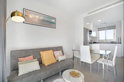 a living room with a couch and a dining room at Luar Candor free parking by Staycare in Rota