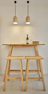 a wooden table with two glasses and two lights at Wehost - Costaluz APARTAMENTO JAZMINES in El Puerto de Santa María