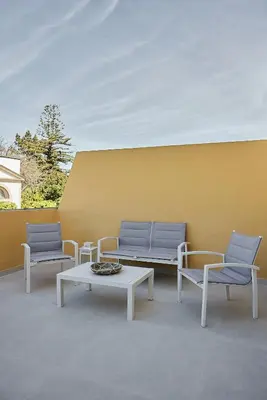 a patio with two chairs and a table and benches at Wehost - Costaluz APARTAMENTO JAZMINES in El Puerto de Santa María
