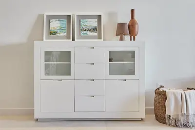 a white dresser in a white room with three windows at Wehost - Costaluz APARTAMENTO JAZMINES in El Puerto de Santa María
