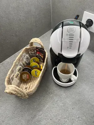 a coffee maker and a cup of coffee on a counter at Wehost - Costaluz APARTAMENTO JAZMINES in El Puerto de Santa María