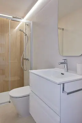a white bathroom with a sink and a shower at Wehost - Costaluz APARTAMENTO JAZMINES in El Puerto de Santa María